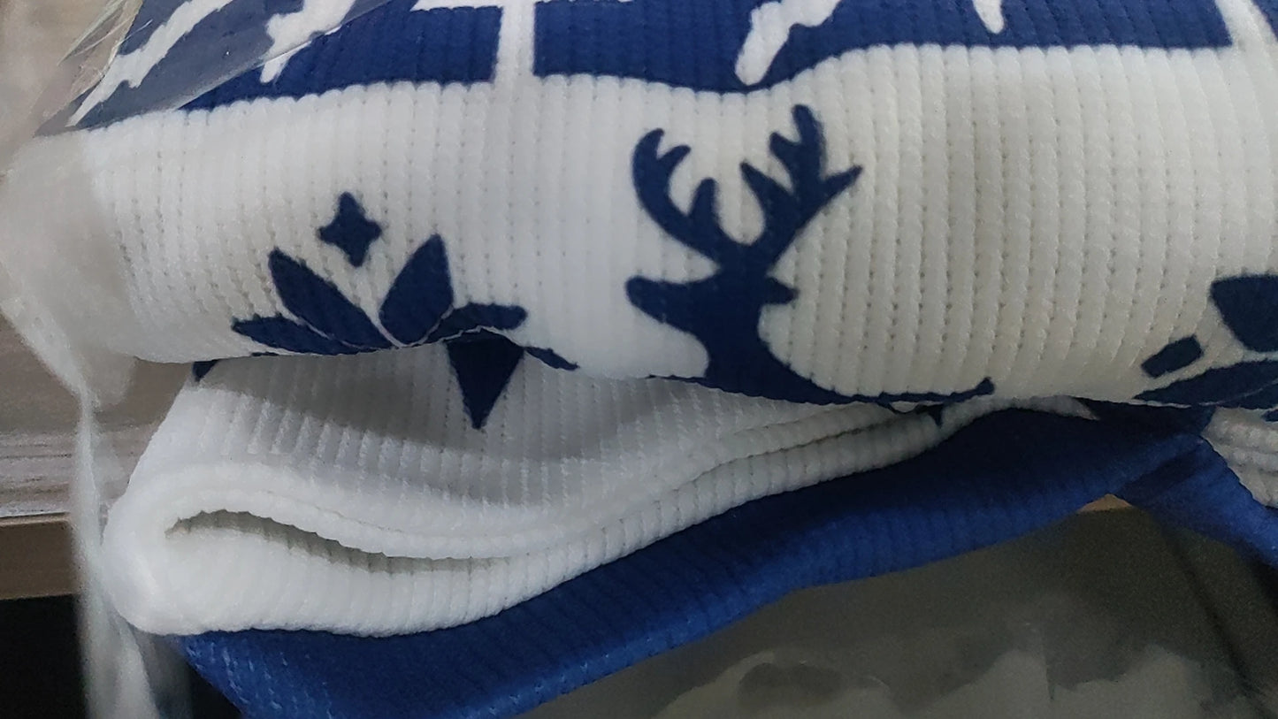 Deer silhouette detail on sweater hem – blue and white knit texture, cozy winter casual design