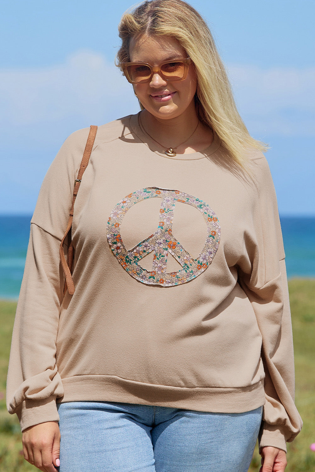 A pale khaki plus-size sweatshirt featuring a floral peace sign graphic and a Washed Terry Finish - ALOE WINGS STORE