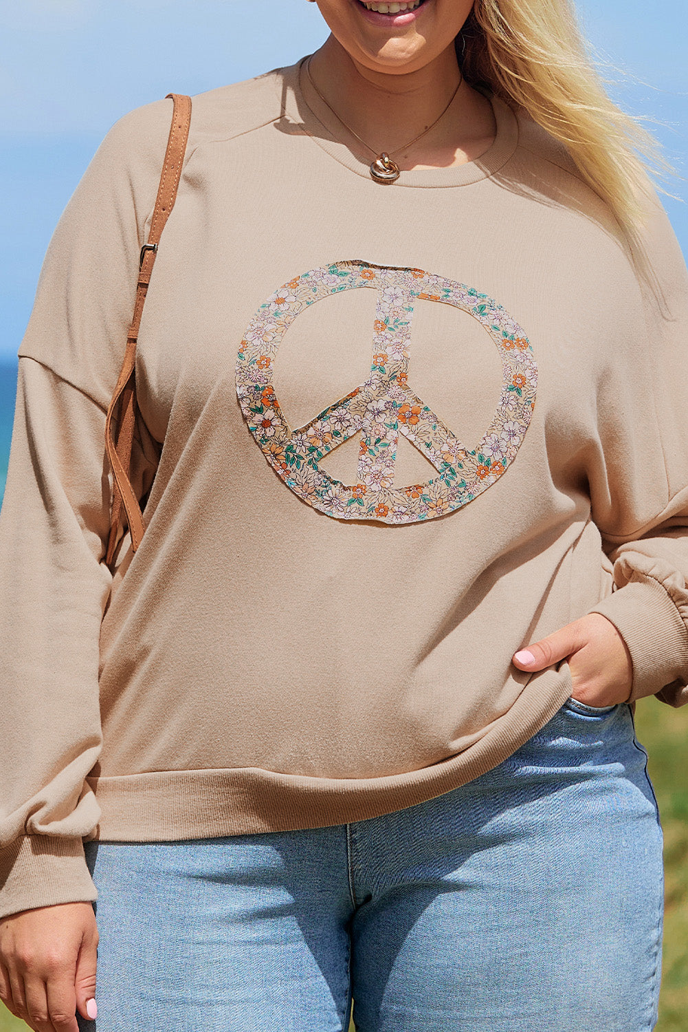 A pale khaki plus-size sweatshirt featuring a floral peace sign graphic and a Washed Terry Finish - ALOE WINGS STORE