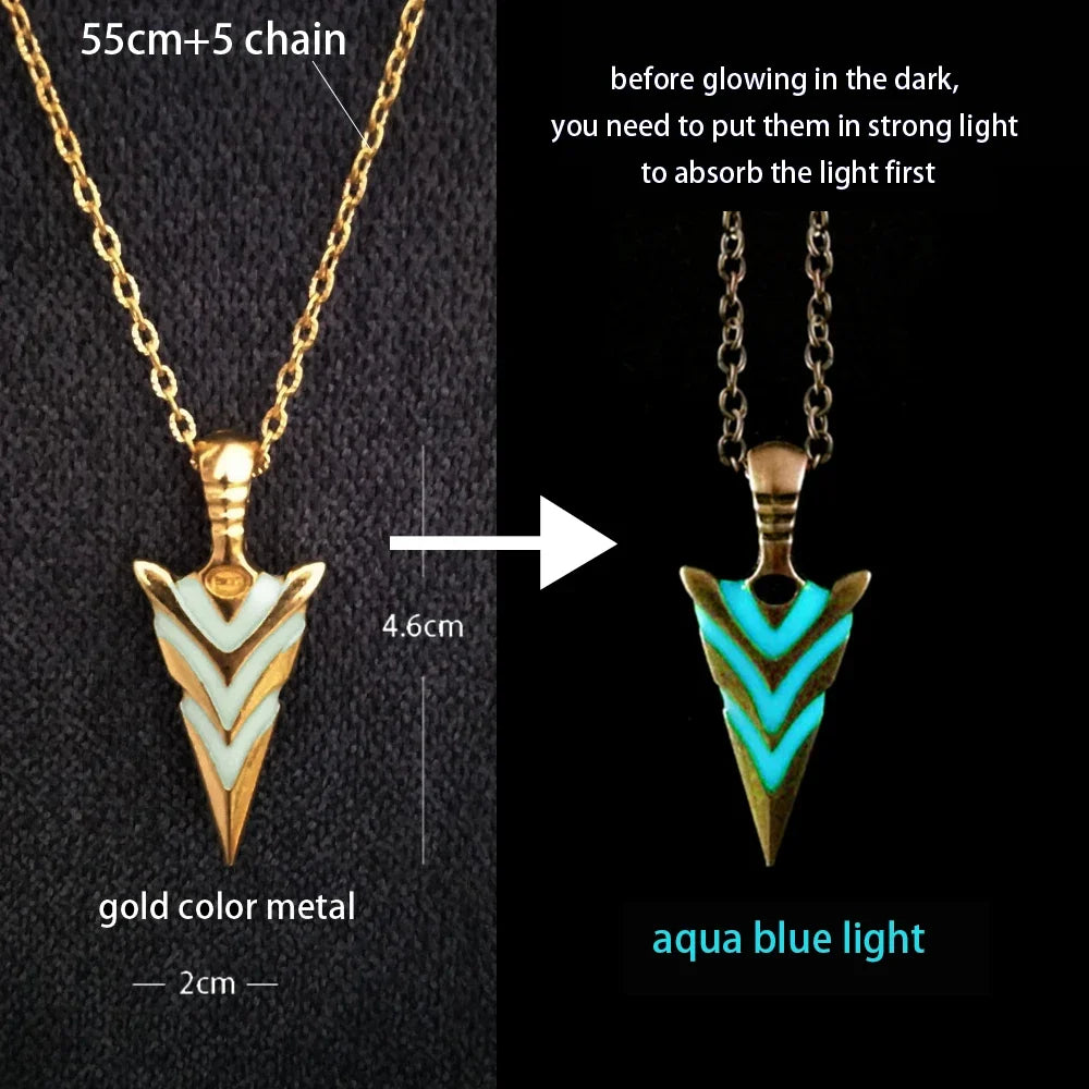 Two arrowhead pendants with gold and aqua blue light on a black background