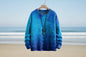 Blue sweater on a hanger with a beach background