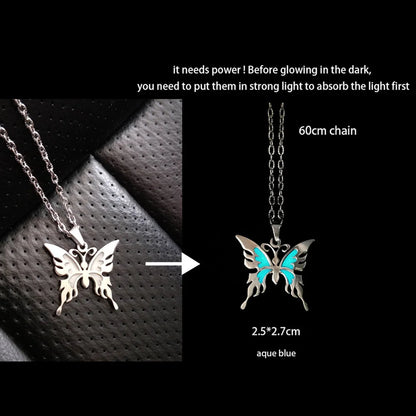 Butterfly-shaped pendant with glowing feature on a black background