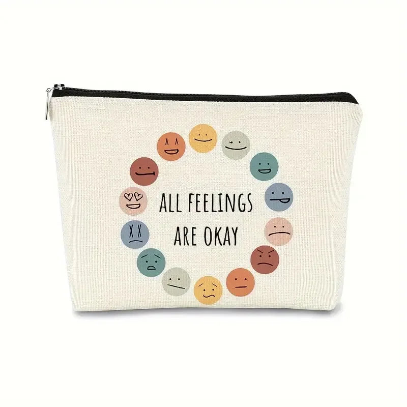 Canvas pouch with smiley face illustrations and 'All feelings are okay' text on a white background