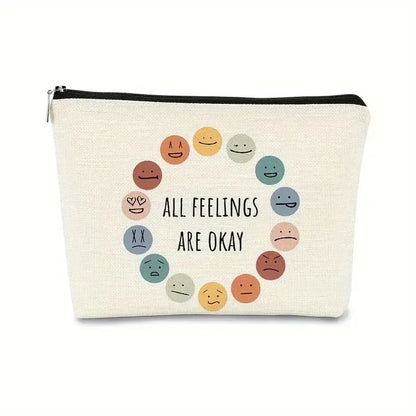 Canvas pouch with smiley face illustrations and 'All feelings are okay' text on a white background