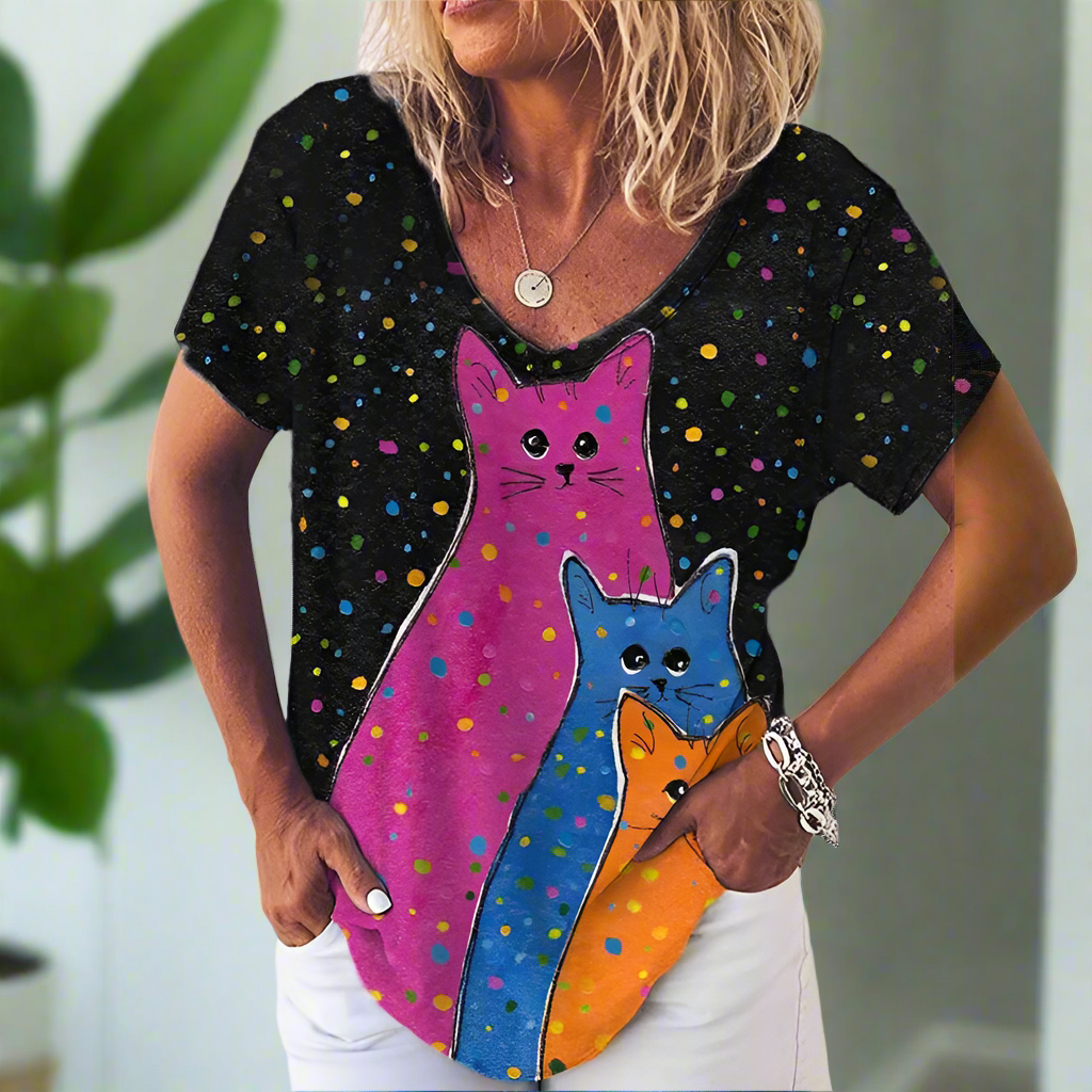Black t-shirt with three large, brightly colored cat silhouettes (pink, blue, orange) on a starry background.