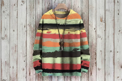 Colorful striped sweater on a wooden hanger against a wooden background