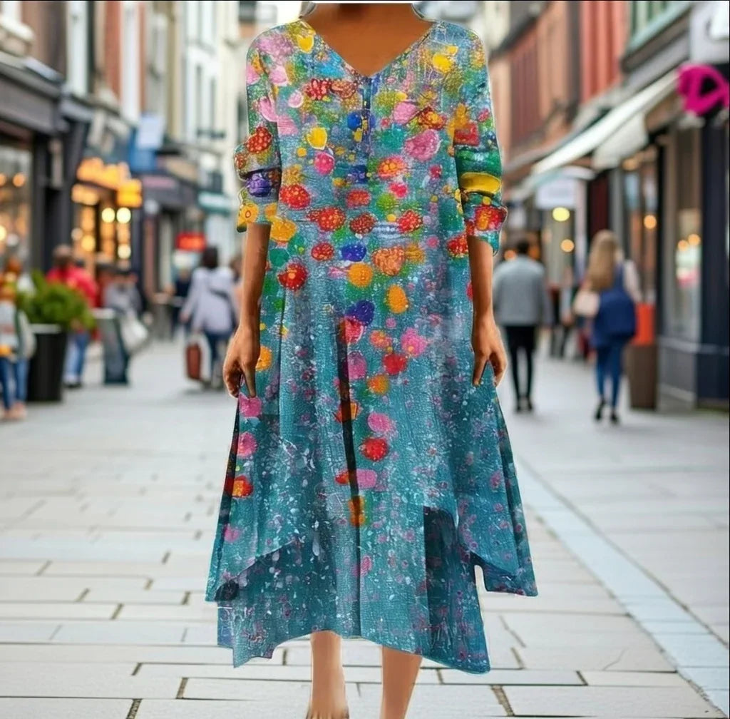 Confident woman in colorful floral maxi dress strolling city street — full sleeves, irregular hem, modern modest fashion.
