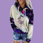 Person wearing a hoodie with a colorful design on a purple background