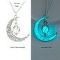 Crescent moon-shaped pendant with glowing effect on a white and gray background