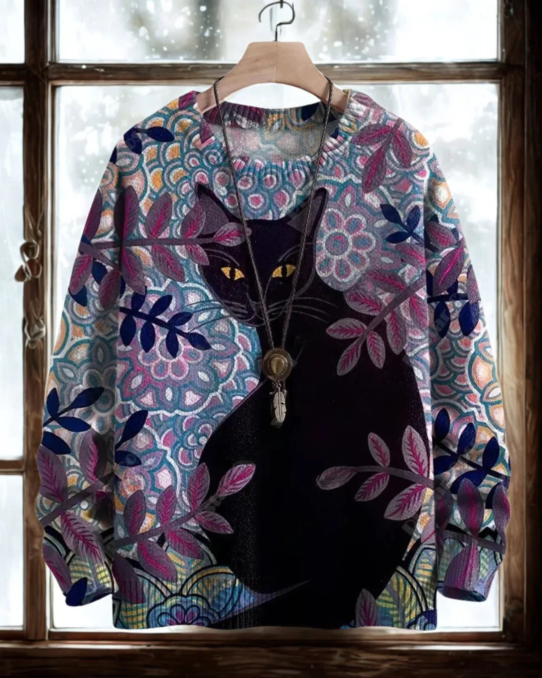 Black cat with glowing eyes on a purple and blue floral patterned 3D sweater