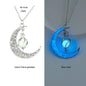 Glowing moon-shaped pendant with chain on a white background