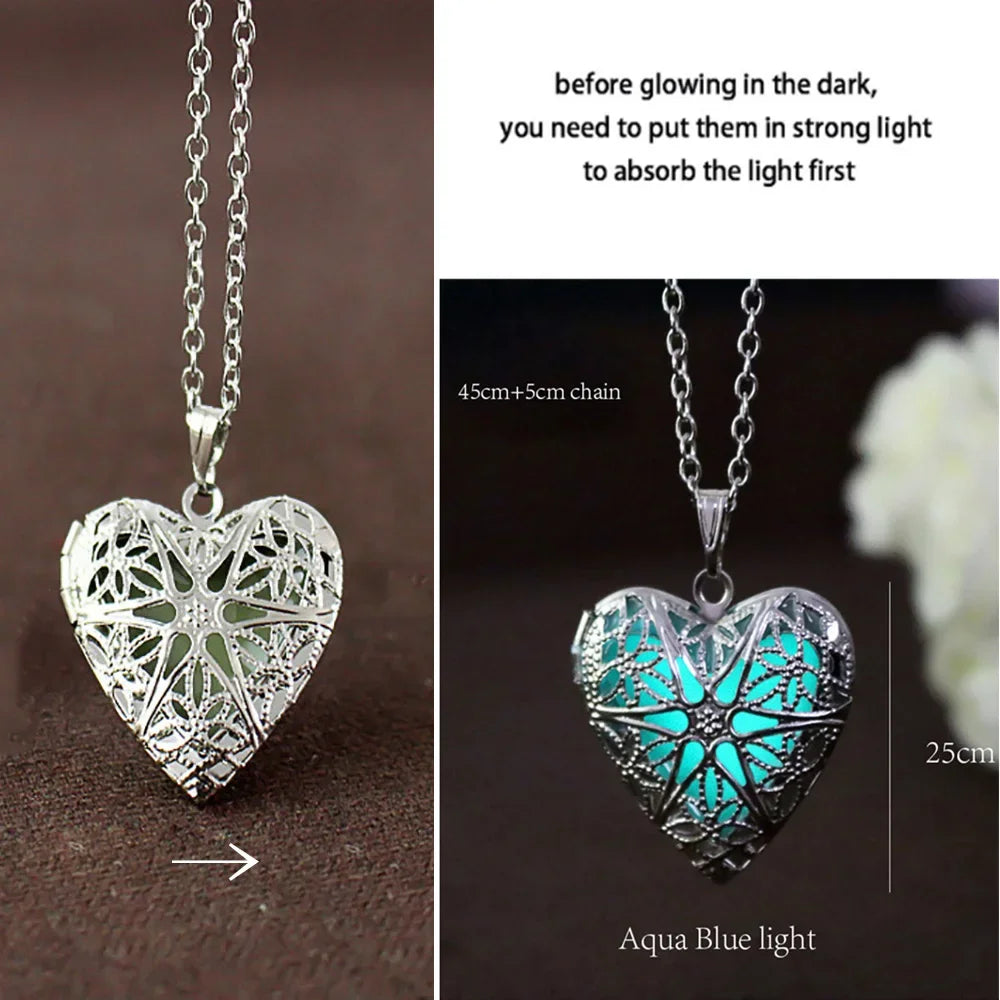 Heart-shaped silver pendant with glowing feature on a dark background