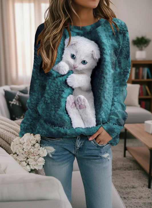 Woman wearing mint green White Cat 3D Design Sweatshirt with realistic kitten print, paired with jeans in cozy living room