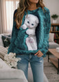 Woman wearing mint green White Cat 3D Design Sweatshirt with realistic kitten print, paired with jeans in cozy living room