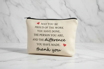 Beige pouch with motivational quote on a marble background