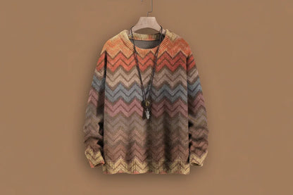 Multicolored zigzag patterned sweater on a hanger against a brown background