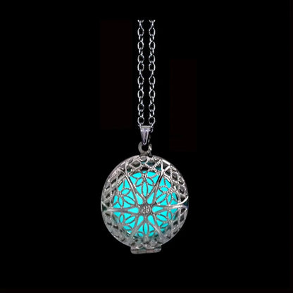 Necklace with a glowing blue pendant on a black background