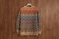 Multicolored zigzag pattern sweater on a wooden background