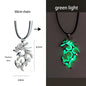 Dragon-shaped necklace with rhodium silver and green light options on a white background.