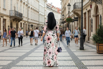 Person wearing a floral dress on a city street with pedestrians.