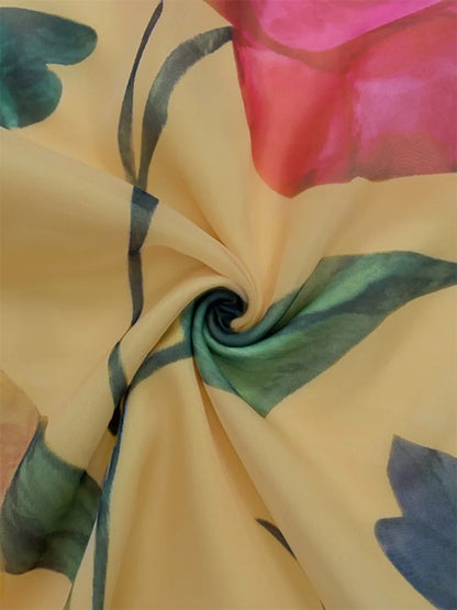 Swirl of Gymystars yellow chiffon fabric with pink and green floral print, showing material texture