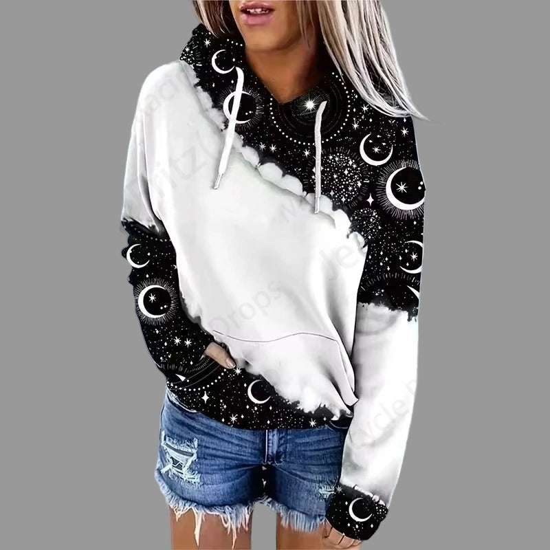 White hoodie with black celestial pattern worn by a person on a gray background