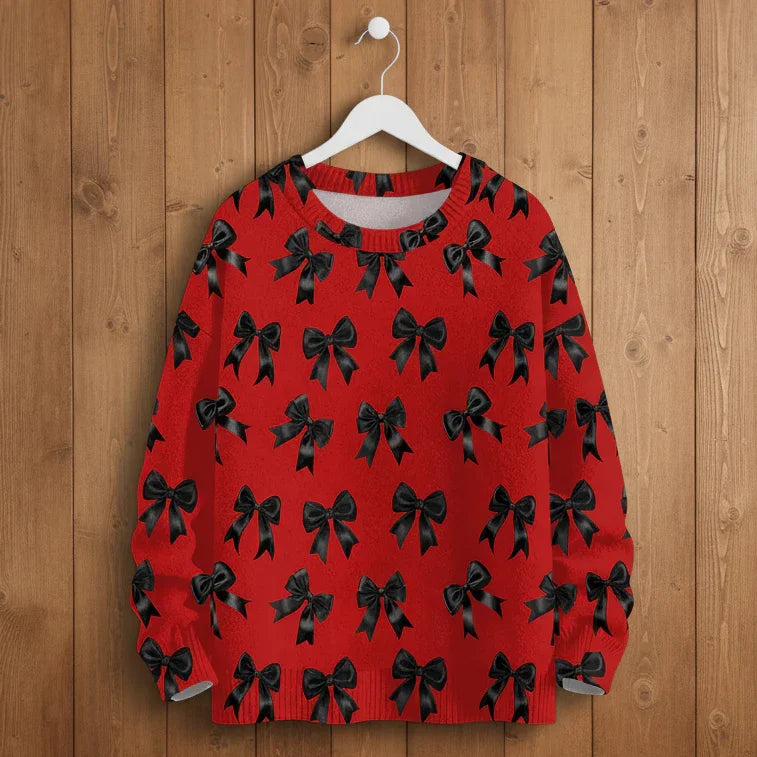 High-quality red crew neck sweatshirt with black bow graphics hanging on a rustic wooden background.