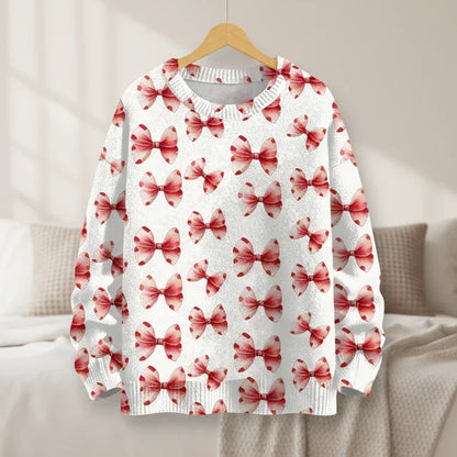 Crisp white sweatshirt with red ribbon prints hanging in a bright, minimalist bedroom.