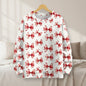 Crisp white sweatshirt with red ribbon prints hanging in a bright, minimalist bedroom.