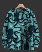 Teal sweater with black octopus pattern on a hanger against a dark background