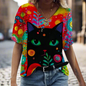  Bold, colorful t-shirt with large black cat face and psychedelic floral patterns.