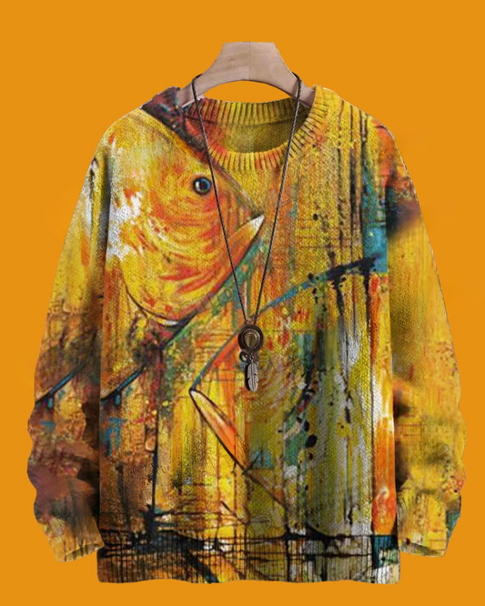 Colorful sweater with abstract design on a hanger against an orange background