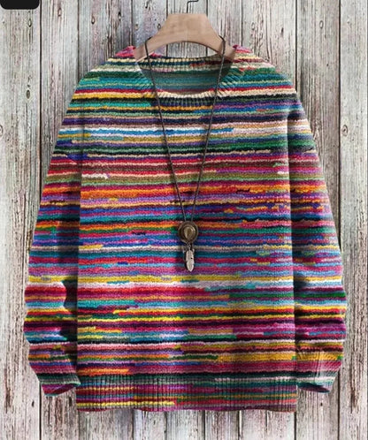 Colorful striped sweater on a wooden hanger against a wooden background