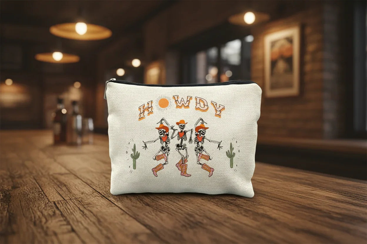 Howdy" design featuring dancing skeletons with cowboy hats and desert cacti pouch.