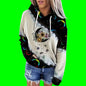 Person wearing a hoodie with a colorful design on a green background