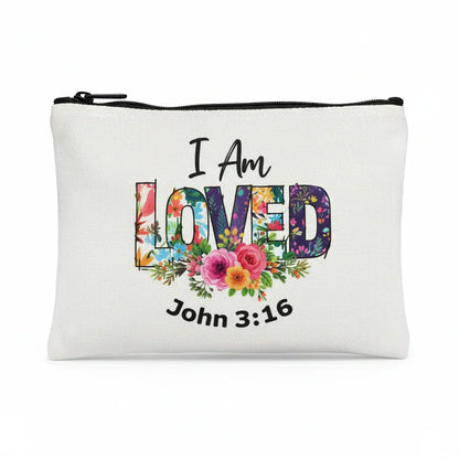 White pouch with 'I Am Loved' text and floral design on a white background
