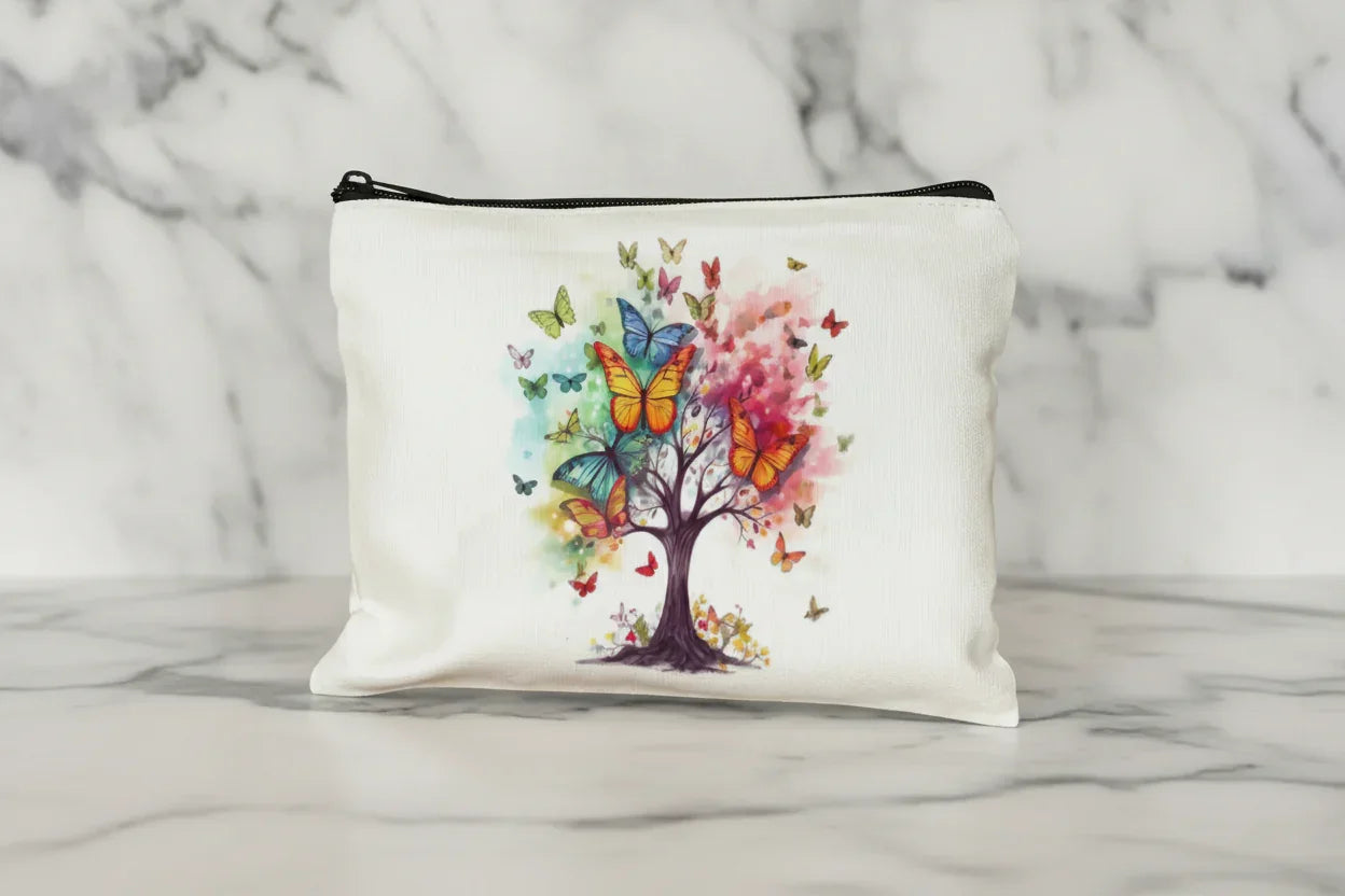 White pouch with a colorful tree and butterflies design on a wooden surface.