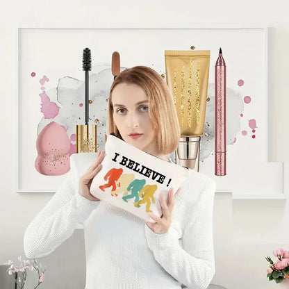 Woman holding a pillow with 'I Believe!' and colourful silhouette design in front of a decorative wall with makeup items.