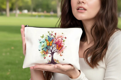 Woman holding a pouch with a colourful tree and butterfly design.