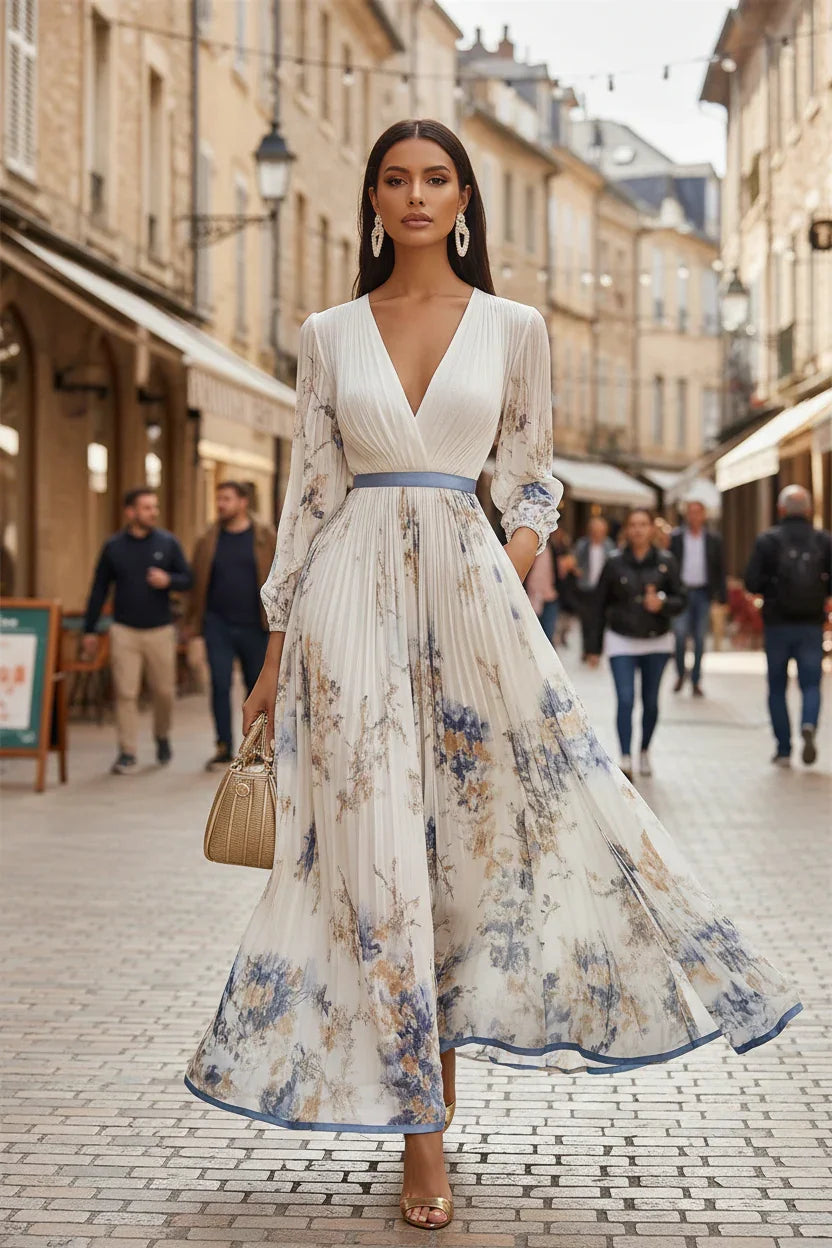 Woman in a floral dress walking down a city street.
