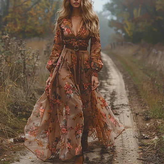 Woman in a floral dress walking on a dirt path in a natural setting