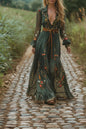 Woman in an embroidered green dress walking on a dirt path in a natural setting