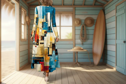 Woman wearing a long, abstract patterned dress with a white wall and plant in the background