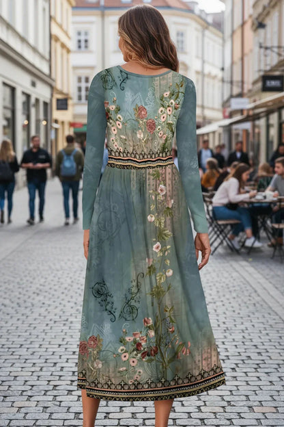 Woman wearing a long, embroidered dress with floral patterns on a street.