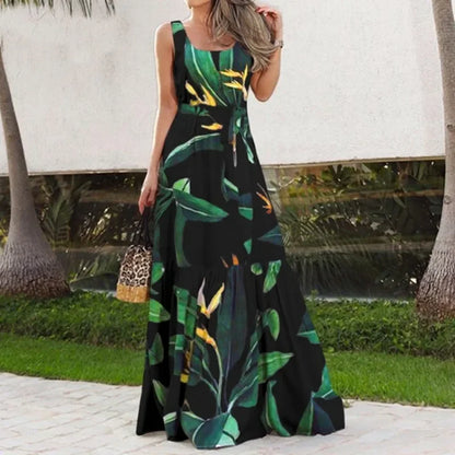 Woman wearing a sleeveless dress with a tropical leaf pattern outdoors.