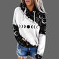 Person wearing a white hoodie with black moon phase design on a gray background