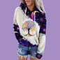 Person wearing a colorful hoodie with a tree of life design on a purple background