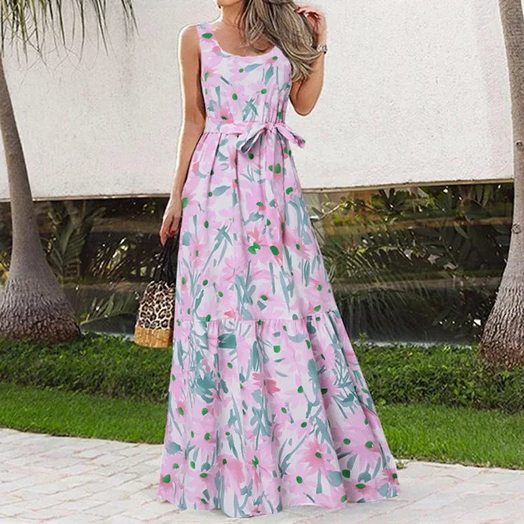 Woman wearing a pink floral dress with a blurred outdoor background