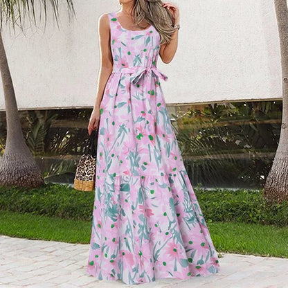Woman wearing a pink floral dress with a blurred outdoor background