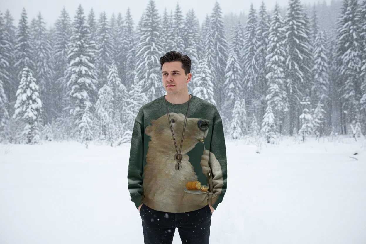 Person wearing a sweater with a bear design in a snowy forest